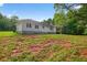 View of the backyard, showcasing the house's covered porch and ample green space at 338 Mount Zion Rd, Oxford, GA 30054