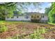 Backyard view of home with a covered porch and spacious layout, great for outdoor activities at 338 Mount Zion Rd, Oxford, GA 30054