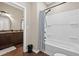 Bathroom with white tub/shower combo with curtain. Sink with dark brown vanity is in background at 338 Mount Zion Rd, Oxford, GA 30054