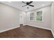 Neutral bedroom with dark wood floors, ceiling fan, and natural light from two windows at 338 Mount Zion Rd, Oxford, GA 30054