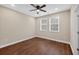 This bedroom features wood floors, a ceiling fan, and two windows that let in natural light at 338 Mount Zion Rd, Oxford, GA 30054