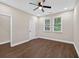 Neutral bedroom with dark wood flooring, ceiling fan, and two bright windows at 338 Mount Zion Rd, Oxford, GA 30054