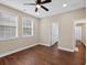 This bedroom features wood floors, a ceiling fan, and two windows that let in natural light at 338 Mount Zion Rd, Oxford, GA 30054