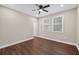 This bedroom features wood floors, a ceiling fan, and two windows that let in natural light at 338 Mount Zion Rd, Oxford, GA 30054