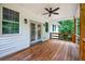 Inviting covered porch with ceiling fan and wooden deck, perfect for outdoor relaxation at 338 Mount Zion Rd, Oxford, GA 30054
