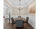 Formal dining room featuring a modern chandelier and a round table with seating for four at 338 Mount Zion Rd, Oxford, GA 30054