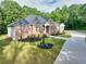 Charming single-Gathering home with manicured lawn, complemented by lush landscaping and long driveway at 338 Mount Zion Rd, Oxford, GA 30054