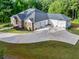 Spacious residence featuring a lengthy driveway, multiple car garage, and a well-maintained lawn at 338 Mount Zion Rd, Oxford, GA 30054