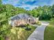 Beautiful brick home with a lush green lawn, elegant landscaping, and a winding concrete driveway at 338 Mount Zion Rd, Oxford, GA 30054