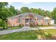 Beautiful brick home with lush landscaping and a paved driveway, blending comfort with curb appeal at 338 Mount Zion Rd, Oxford, GA 30054