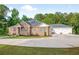 Expansive brick house with a three-car garage and extensive driveway, perfect for ample parking at 338 Mount Zion Rd, Oxford, GA 30054