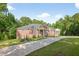 Charming brick home with a well-manicured front yard and a long driveway, surrounded by mature trees at 338 Mount Zion Rd, Oxford, GA 30054