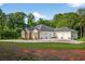 Spacious home exterior featuring a large driveway leading to a three-car garage at 338 Mount Zion Rd, Oxford, GA 30054
