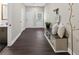 This hallway features wood floors, a decorative bench, and doorways to other rooms at 338 Mount Zion Rd, Oxford, GA 30054