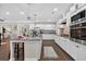Spacious kitchen featuring white cabinets, a large island, stainless steel appliances, and hardwood flooring at 338 Mount Zion Rd, Oxford, GA 30054