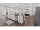 Open-concept kitchen with island, stainless steel appliances, and hardwood floors, leading to dining area at 338 Mount Zion Rd, Oxford, GA 30054