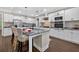 Bright kitchen with white cabinets, granite countertops, island with seating, and stainless-steel appliances at 338 Mount Zion Rd, Oxford, GA 30054