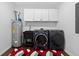 This laundry room features a utility sink, washer, dryer, and overhead cabinets at 338 Mount Zion Rd, Oxford, GA 30054