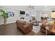 Open-concept living room with hardwood floors, fireplace, and ceiling fan provides an airy and welcoming space at 338 Mount Zion Rd, Oxford, GA 30054
