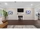 Beautifully staged living room with electric fireplace, hardwood floors, and modern decor at 338 Mount Zion Rd, Oxford, GA 30054