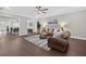 Open-concept living room, featuring hardwood floors, a ceiling fan, and access to the dining room at 338 Mount Zion Rd, Oxford, GA 30054