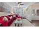 Cozy living room featuring a plush magenta sofa, wainscoting and natural light from the windows at 338 Mount Zion Rd, Oxford, GA 30054