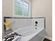 Contemporary bathroom with a soaking tub, marble surround, and modern fixtures at 338 Mount Zion Rd, Oxford, GA 30054