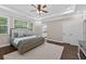 Bright and spacious main bedroom featuring hardwood floors, tray ceiling, and ample natural light from windows at 338 Mount Zion Rd, Oxford, GA 30054