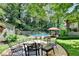 Backyard with pool, fire pit, and outdoor seating, perfect for entertaining at 4562 Lucerne Valley Sw Rd, Lilburn, GA 30047