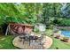 Picturesque backyard features a fire pit area, storage sheds, and a refreshing pool at 4562 Lucerne Valley Sw Rd, Lilburn, GA 30047