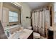 Bathroom featuring a vanity, toilet, and shower with leaf-patterned curtain at 4562 Lucerne Valley Sw Rd, Lilburn, GA 30047
