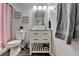 Bathroom features a vanity with storage, a silver framed mirror, and neutral wall color at 4562 Lucerne Valley Sw Rd, Lilburn, GA 30047