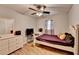Bright bedroom features a ceiling fan, a window, and a neutral color palette at 4562 Lucerne Valley Sw Rd, Lilburn, GA 30047