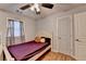 Bedroom features a ceiling fan, a window, and a gray color palette at 4562 Lucerne Valley Sw Rd, Lilburn, GA 30047
