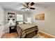 Cozy bedroom boasts wood floors, soft lighting, and decorative wall art at 4562 Lucerne Valley Sw Rd, Lilburn, GA 30047