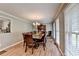 Elegant dining room with hardwood floors and abundant natural light at 4562 Lucerne Valley Sw Rd, Lilburn, GA 30047
