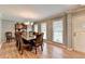 Bright dining room features hardwood floors, large window, and modern chandelier at 4562 Lucerne Valley Sw Rd, Lilburn, GA 30047
