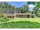 Charming two-story home with a well-manicured lawn and mature trees at 4562 Lucerne Valley Sw Rd, Lilburn, GA 30047