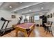 Brightly lit game room featuring a billiard table and exercise equipment at 4562 Lucerne Valley Sw Rd, Lilburn, GA 30047