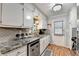 Well-lit kitchen boasts modern appliances, granite countertops, and ample storage at 4562 Lucerne Valley Sw Rd, Lilburn, GA 30047