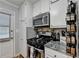 Efficient kitchen with stainless steel appliances, modern range, and stylish backsplash at 4562 Lucerne Valley Sw Rd, Lilburn, GA 30047