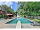 Relax in the in-ground pool within the fenced backyard, near the poolside seating and lush landscaping at 4562 Lucerne Valley Sw Rd, Lilburn, GA 30047