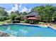 Inviting backyard pool with lounge chairs and umbrella, perfect for relaxing and entertaining outdoors at 4562 Lucerne Valley Sw Rd, Lilburn, GA 30047