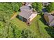 Aerial view highlights the back of a home with a screened porch, complemented by manicured landscaping and lush trees at 601 Laurel Xing, Canton, GA 30114