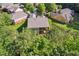 An aerial view showcases the back of a home featuring a screened porch overlooking well-maintained landscaping at 601 Laurel Xing, Canton, GA 30114