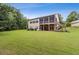 The back of this tan house showing an expansive backyard with a screened in porch at 601 Laurel Xing, Canton, GA 30114