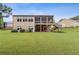 Expansive backyard showcasing the home's exterior with a screened porch, deck, and lush lawn at 601 Laurel Xing, Canton, GA 30114