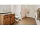 Bathroom featuring a single sink vanity and a shower-tub combo with tile floors at 601 Laurel Xing, Canton, GA 30114