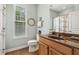 Bathroom with earthy tones, a double sink vanity, and tile floors plus a window for natural light and ventilation at 601 Laurel Xing, Canton, GA 30114