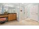 Bathroom with glass shower, vanity, cabinets, mirror, and natural light at 601 Laurel Xing, Canton, GA 30114
